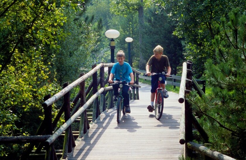 Two boys cycling over a bridge Centre Parcs France Centre Parcs Center Parcs Parcs Les Bois Francs Verneuil sur Avre L Oise Norm