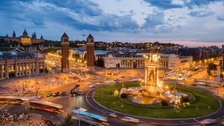 Traffic around Plaza de Espana historical square at dusk in Barcelona, Catalunya, Spain.