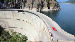 VIDRARU DAM, ROMANIA - AUGUST 23, 2012: People visit Vidraru Dam in Romania. Vidraru Hydro Power Plant has an installed capacity of 220 megawatts.
