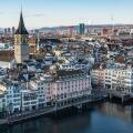 Zurich, Switzerland, Jan. 4, 2026. View of Zurich from Grossmunster tower showing the snowy rooftops, the Limmat river and the St. Peter church