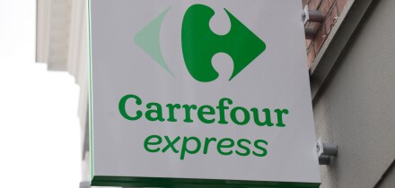 The Carrefour Express logo above a store in Bruges, Belgium.