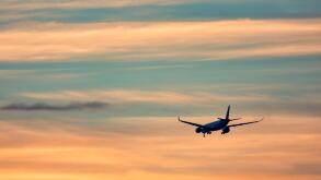 Airplane taking off in the sunset