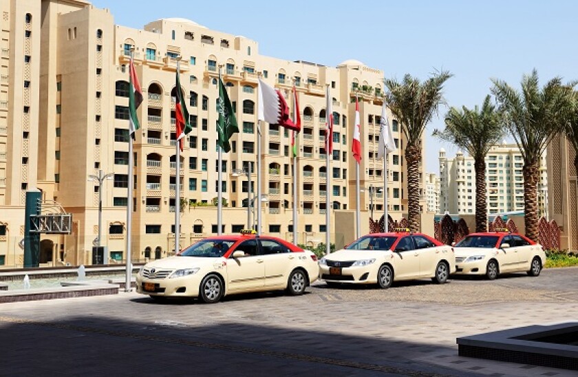 The Dubai Taxi cars waiting for clients near hotel, Dubai, UAE.