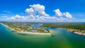 Aerial view of southern Naples FL at Gordon Pass overlooking Port Royal luxury real estate area.