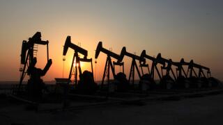 Oil pumps work in the desert oil fields of Sakhir, Bahrain. (Photo/Hasan Jamali)