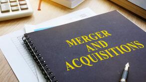 Book about Merger And Acquisitions M&A on a desk.