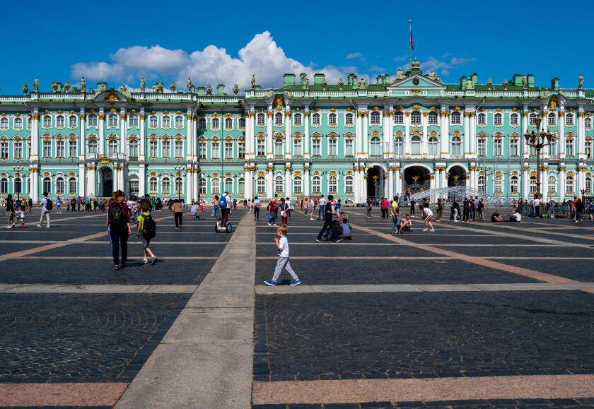 St. Petersburg, Russia -- July 21, 2019. Photo of people walking around in the square outside the Winter Palace in St Petersburg, Russia.