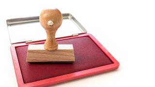 rectangular rubber stamp on ink pad on white desk