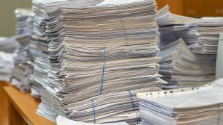 Desk_mess_documents_filing_575x375_Adobe_230120