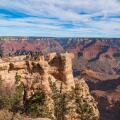 Grand Canyon national park, Arizona. Tourists admiring the panoramic view from one of the view points on the south rim, in November, bright light