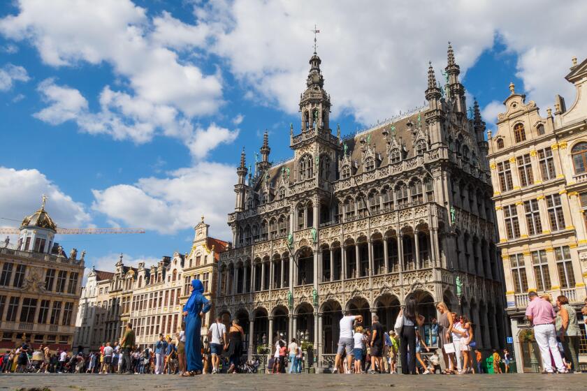 Brussels, Belgium - August 20 2022 : Tourists discovering the famous Grand Place and the historical buildings in Brussels