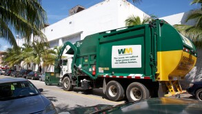 refuse truck collecting rubbish bins in miami south beach florida usa