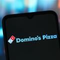 In this photo illustration, the Domino's Pizza logo is seen displayed on a smartphone screen.
