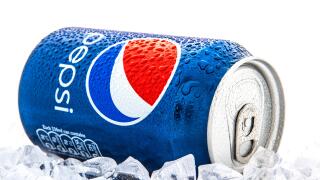 Can of Pepsi cola on a bed of ice and white background, Pepsi is a carbonated soft drink produce