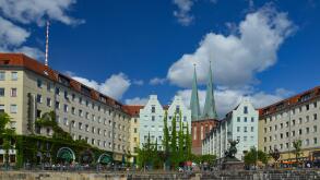 A beautiful shot of a neighborhood of old houses against blue sky in bright sunlight in Berlin, Germany.