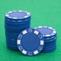 lots of blue poker chips on casino table