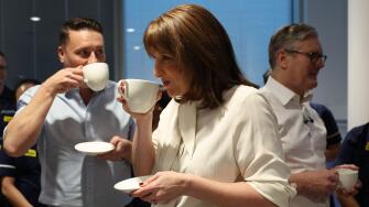 Britain's Chancellor of the Exchequer Rachel Reeves, center, Britain's Health Secretary Wes Streeting, left, and Britain's Prime Minister Keir Starmer hold hot drinks as they talk with Nurses during a visit to University College London Hospital in London,