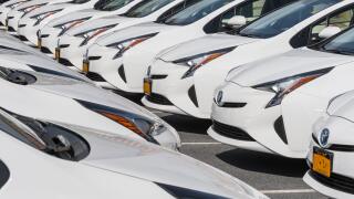 Rows Of White Cars In Car Dealership Parking Lot