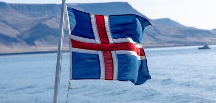 Icelandic flag flying on a boat.