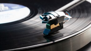 Playing a vinyl record on a record player - LP record on a retro turntable  with tone arm and cartridge