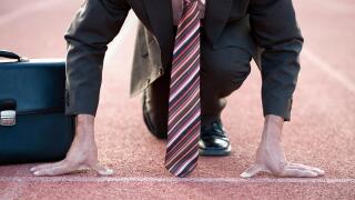 Businessman at starting line of a running track