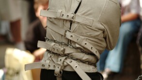 straight jacket street entertainer mad looney mental health handcuff tied up chain lock locked key strap escapologist escape jai