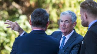 File - Federal Reserve Chair Jerome Powell, center, talks with attendees of the central bank's annual symposium at Jackson Lake Lodge in Grand Teton National Park, Aug. 26, 2022. in Moran, Wyo. As Powell returns to Jackson Hole this week, the U.S. economy