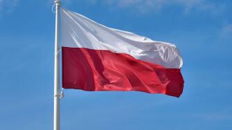 Polish flag against blue sky