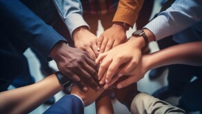A close up top view shot of multinational business people joining hands together, teamwork build up concept. Generative AI.