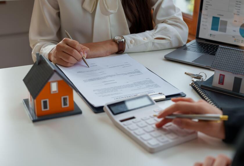 Real estate brokers calculation for loan rating and advise customers to sign their names. Real estate agent, property broker, real estate investment