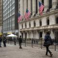 People walk past the New York Stock Exchange (NYSE) on Wall Street on March 4, 2026 in New York.