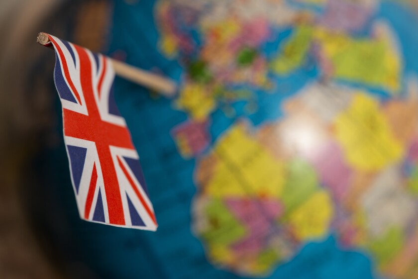 British flag on the world map points to the United Kingdom.