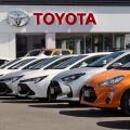 New Toyota vehicles displayed outside dealership showroom in Wellington, New Zealand.