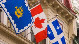 QUEBEC CITY, QUEBEC, CANADA - National and regional flags on display in Quebec City. L-R: City of Quebec; Canada; Quebec
