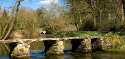 St.John's Bridge, a clapper bridge in Eastleach in Gloucestershire, Cotswolds, England, UK over the River Leach.. Image shot 03/2006. Exact date unknown.