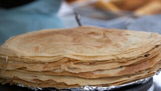 pile of crepes warming on a food stall at an outdoor food market in the uk