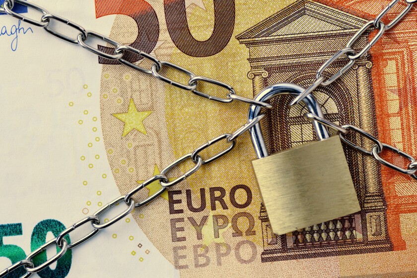 Closeup of 50 euro banknote locked with chain and padlock - Conc