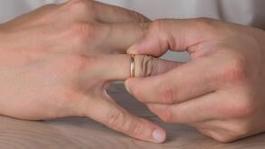 Divorce, separation: man removing wedding or engagement ring