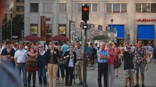 People at pedestrian crossing waiting for the green light. Berlin, Germany.