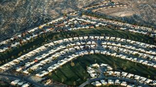 An aerial view shows the sun rising on a Palm Desert housing development in the Coachella Valley in Southern California, USA. This growing retirement haven east of Los Angeles includes the upscale communities of Rancho Mirage and La Quinta, as well as the