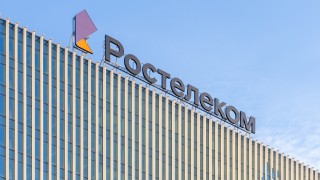 Close-up of signboard Rostelecom at the top of the building.