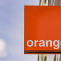 Orange mobile company logo hanging in exterior