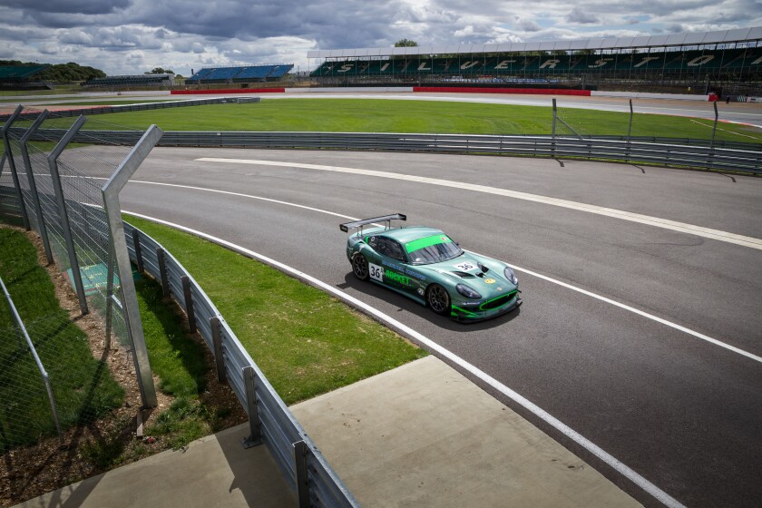 A racing car entering the pits on a track day at Silverstone Racing Circuit, Towcester, England.