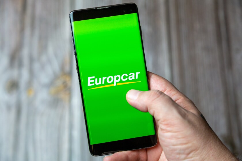 02-24-2021 Portsmouth, Hampshire, UK A mobile phone or cell phone being held by a hand with the Europcar app open on screen