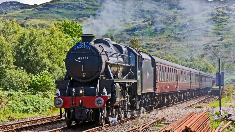The Jacobite steam train approaches Arisaig railway station at Arisaig in the West Highlands of Scotland