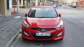 red hyundai elantra car parked street germany europe