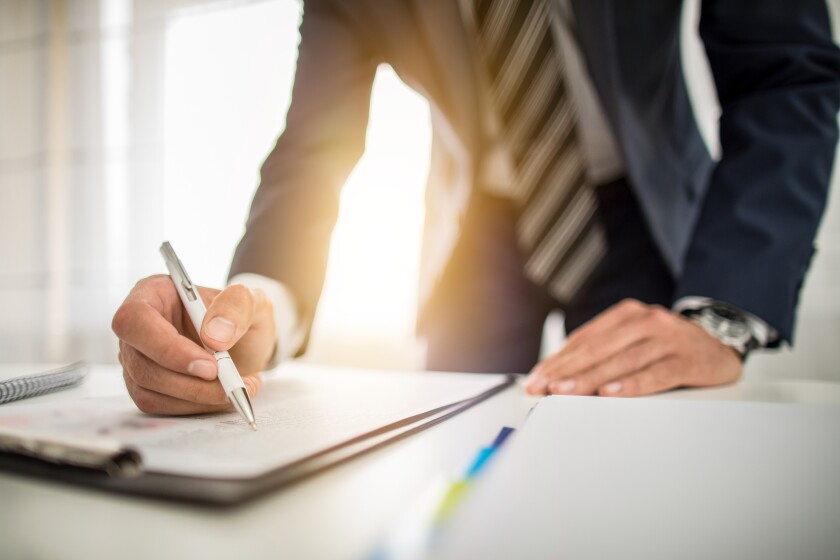 Business man signing contract, making a deal.