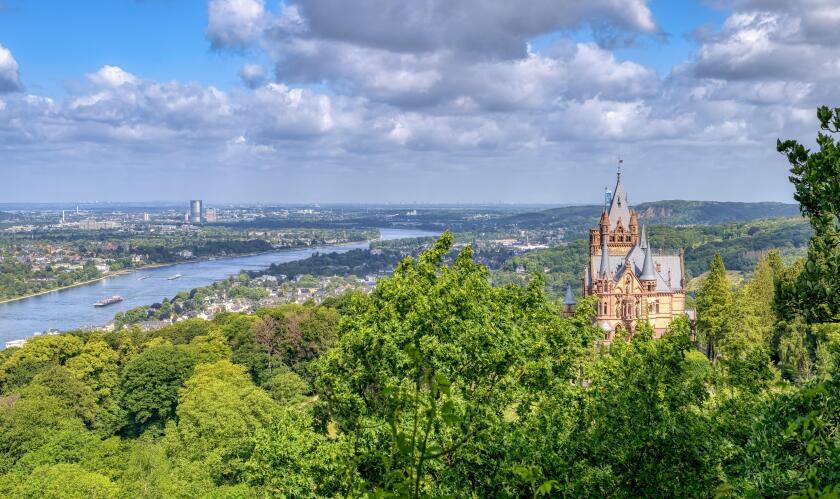 Panoramic view over the castle Drachenburg on the hill Drachenfels in Siebengebirge, town Konigswinter and Bonn, river Rhine and Cologne Lowland, NRW