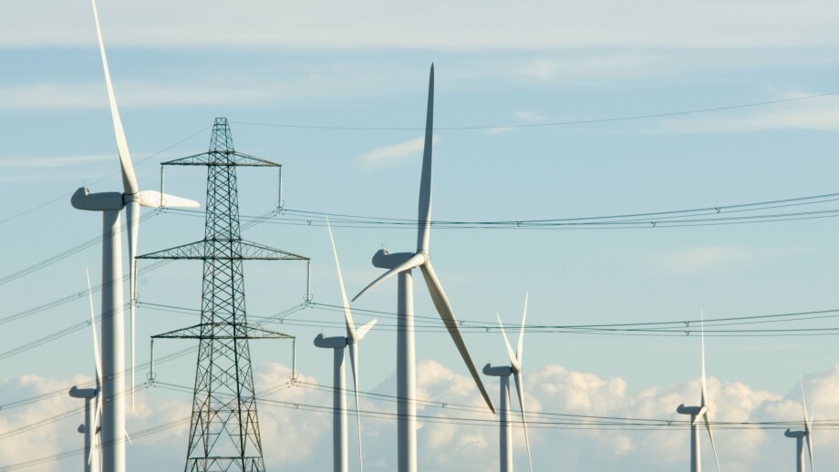 National Grid electricity transmission lines and pylons next to Nordex wind turbines at Little Cheyne Court wind farm Rye Sussex. Image shot 10/2010. Exact date unknown.