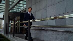 Ambitious businessman leaving office center after successful meeting, routine